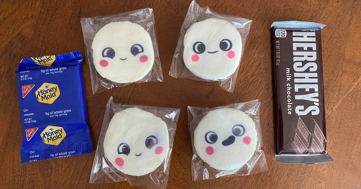 robots for kids, Photo contains a package of graham crackers on the left, four white Snorble marshmallows in the middle, and a Hershey chocolate bar on the right.