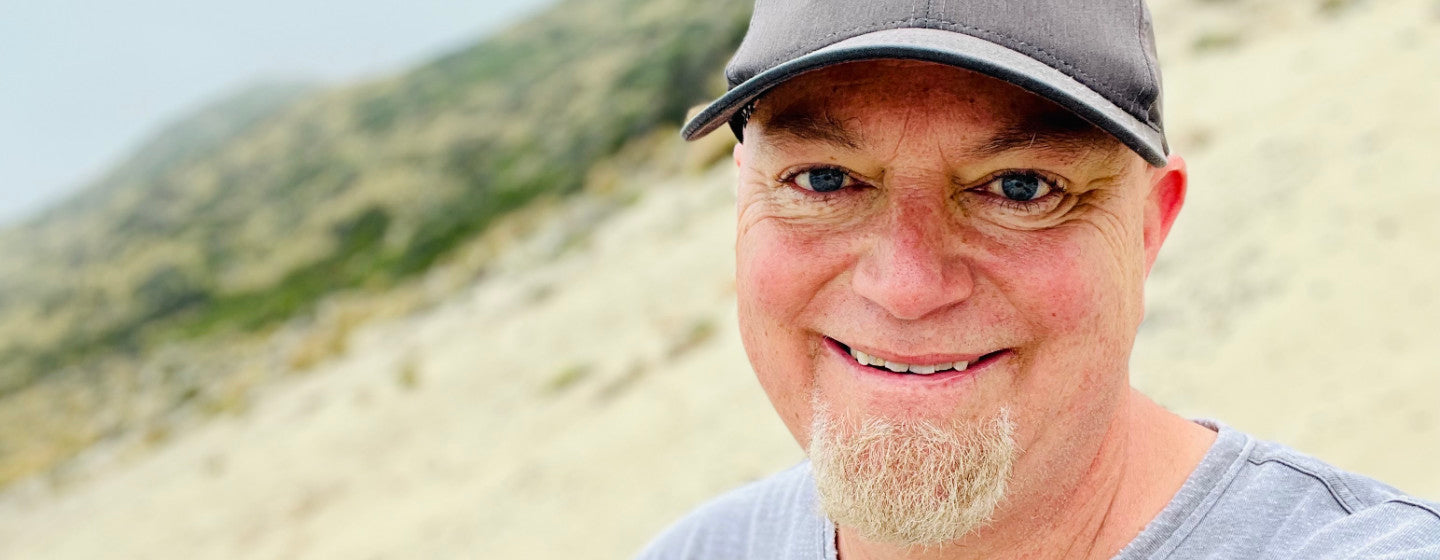 Image contains a photo of Steve Hecker, Snorble's Chief Technology Officer, and he is smiling at the camera with a beach in the background.