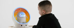 Image contains a photo of a young child talking with Snorble®, an intelligent companion.
