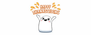 Image contains an illustraton of Snorble®, an adorable sleep companion for children, with the words "Happy Thanksgiving" above their head in orange. On both sides of the words, there are also orange leaves.